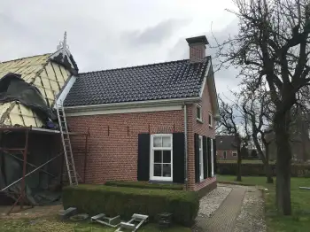 In Midwolde nieuwe koramic vhv zwart verglaasde dakpannen gelegd.